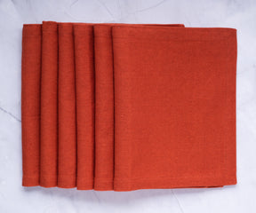 Protect and adorn your dining table with red fabric placemats, adding a touch of elegance to your mealtimes.