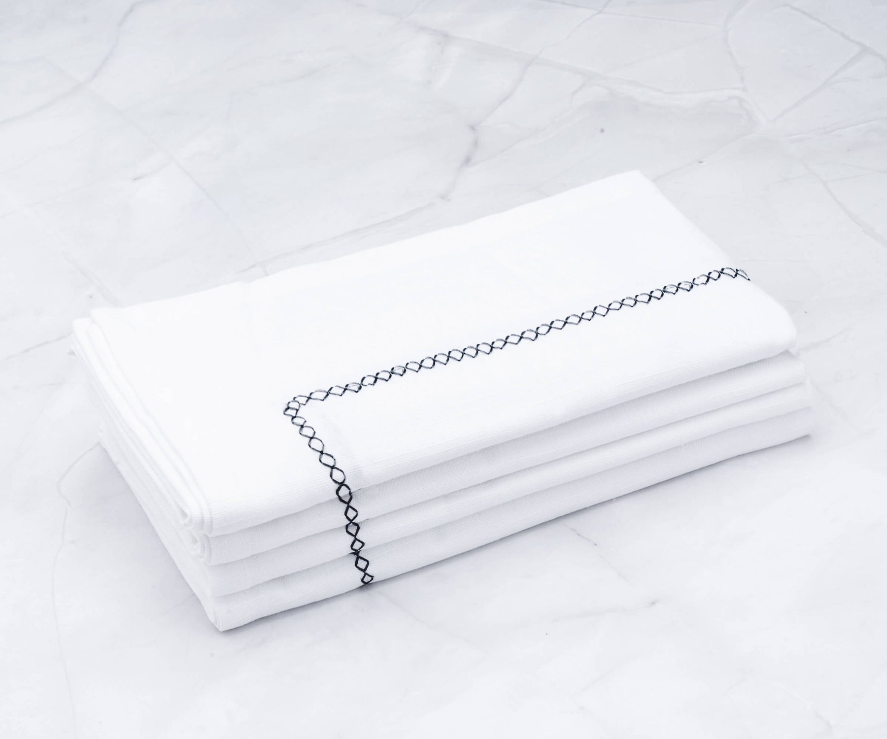  There are cloth dinner napkins, Vanity Fair dinner napkins, neatly folded dinner napkins, white cotton napkins, and instructions on how to fold napkins for dinner.