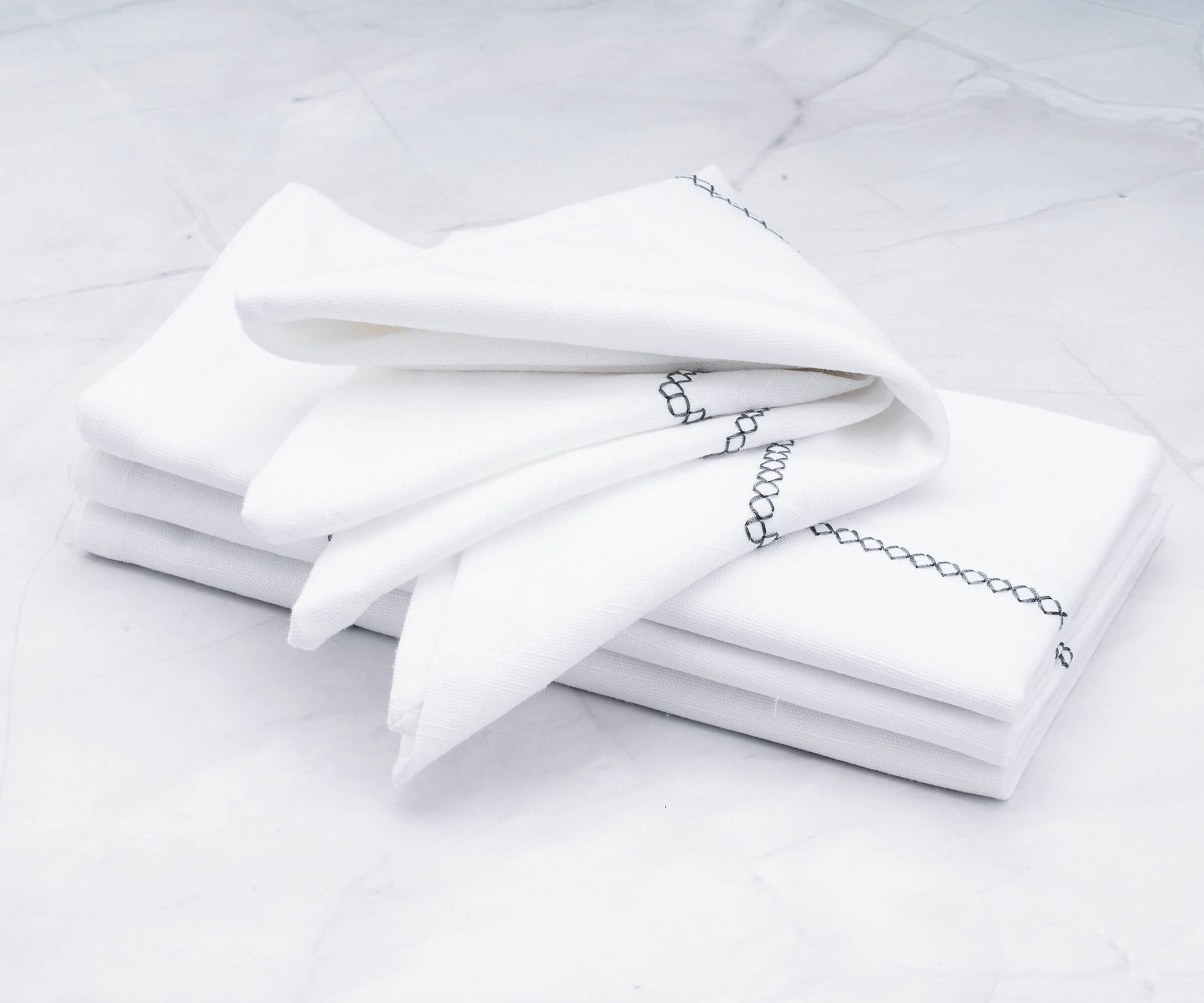 Instructions on how to fold dinner napkins, along with cotton cloth napkins, rehearsal dinner napkins, and custom dinner napkins, are all part of the available options.