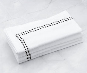Cloth dinner napkins, such as cotton ones, can be elegantly folded using various techniques. Vanity Fair offers high-quality dinner napkins, and for a personalized touch, you can opt for monogrammed dinner napkins.