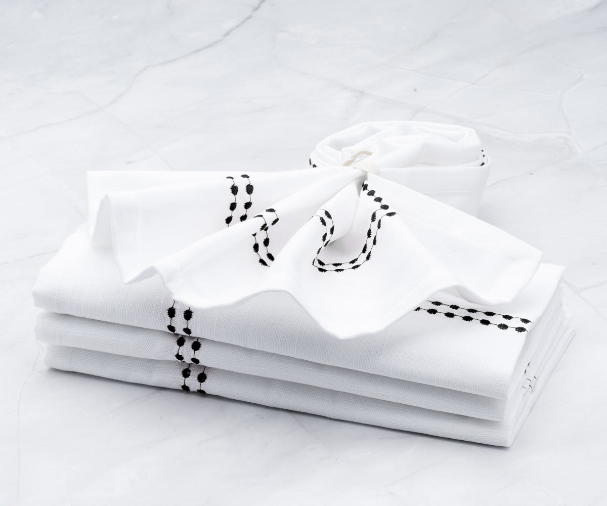 The white hemstitch napkins white come in a value pack of 4. Embroidered napkins elevate your dining experience with cotton dinner napkins.