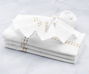 Gold dinner napkins elegantly, including techniques for folding them with rings. White dinner napkins are a classic choice, and they are commonly used during rehearsal dinners.Beautiful Display of Gold Cloth Napkins in a Basket