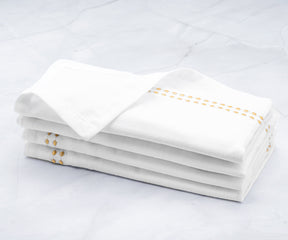 Gold dinner napkins White napkins add an elegant touch to any table setting.