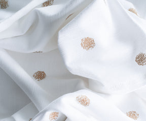White tablecloth with metallic pattern, wedding-ready.