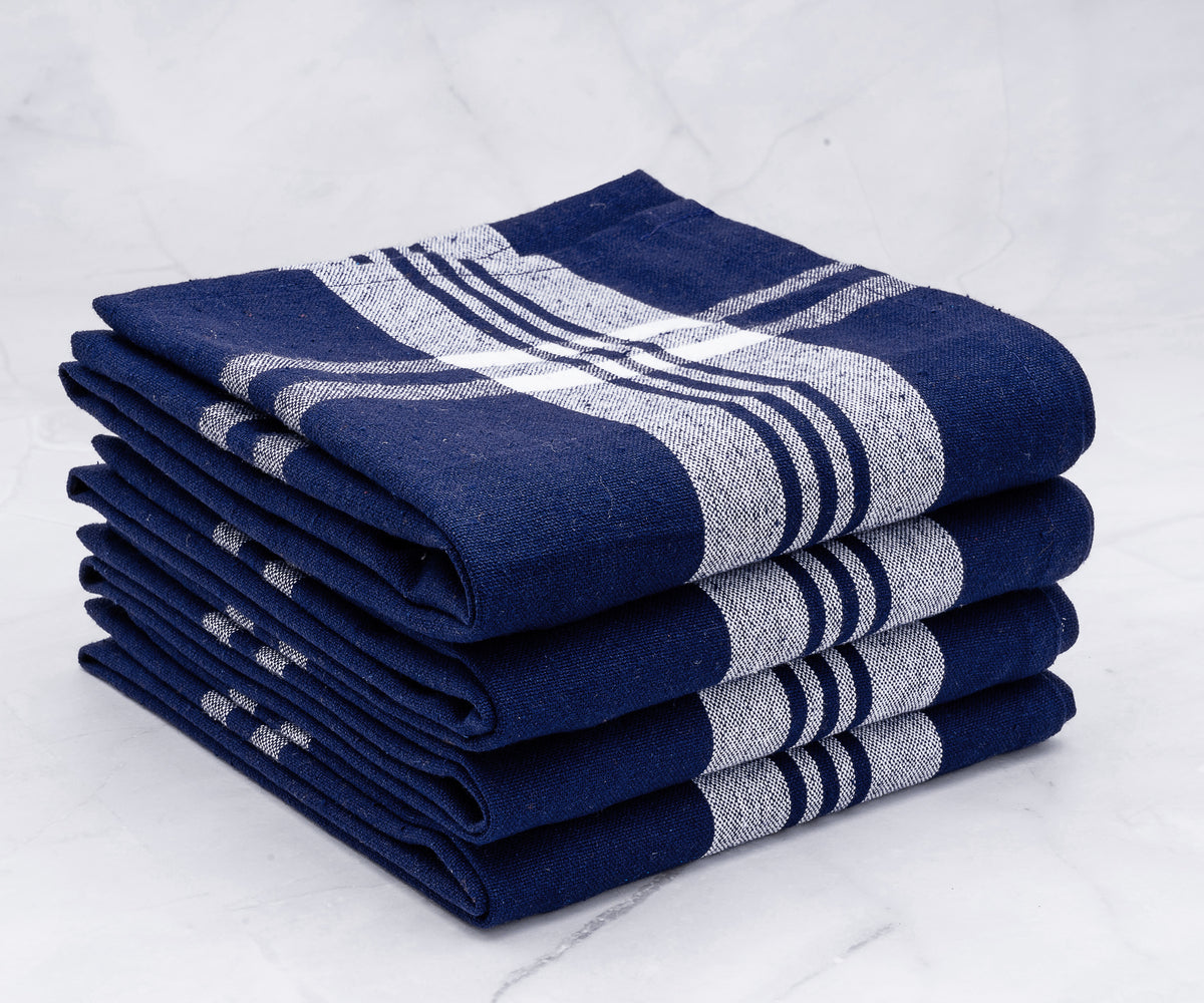 Four blue and white striped kitchen towels neatly stacked