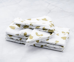 Cloth Dinner Napkins: Folded set of 4 White napkins-Metal printed napkins  are arranged one above another.