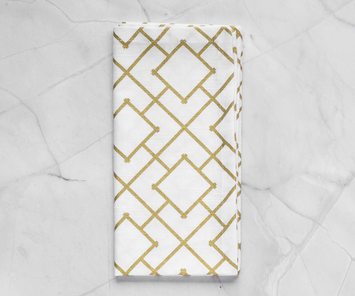 Folded metallic gold napkins-custom printed napkins arranged in white background.