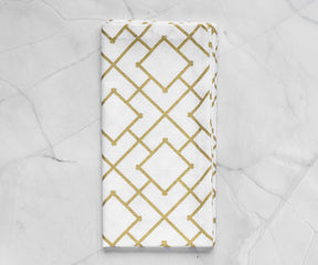 Folded metallic gold napkins-custom printed napkins arranged in white background.