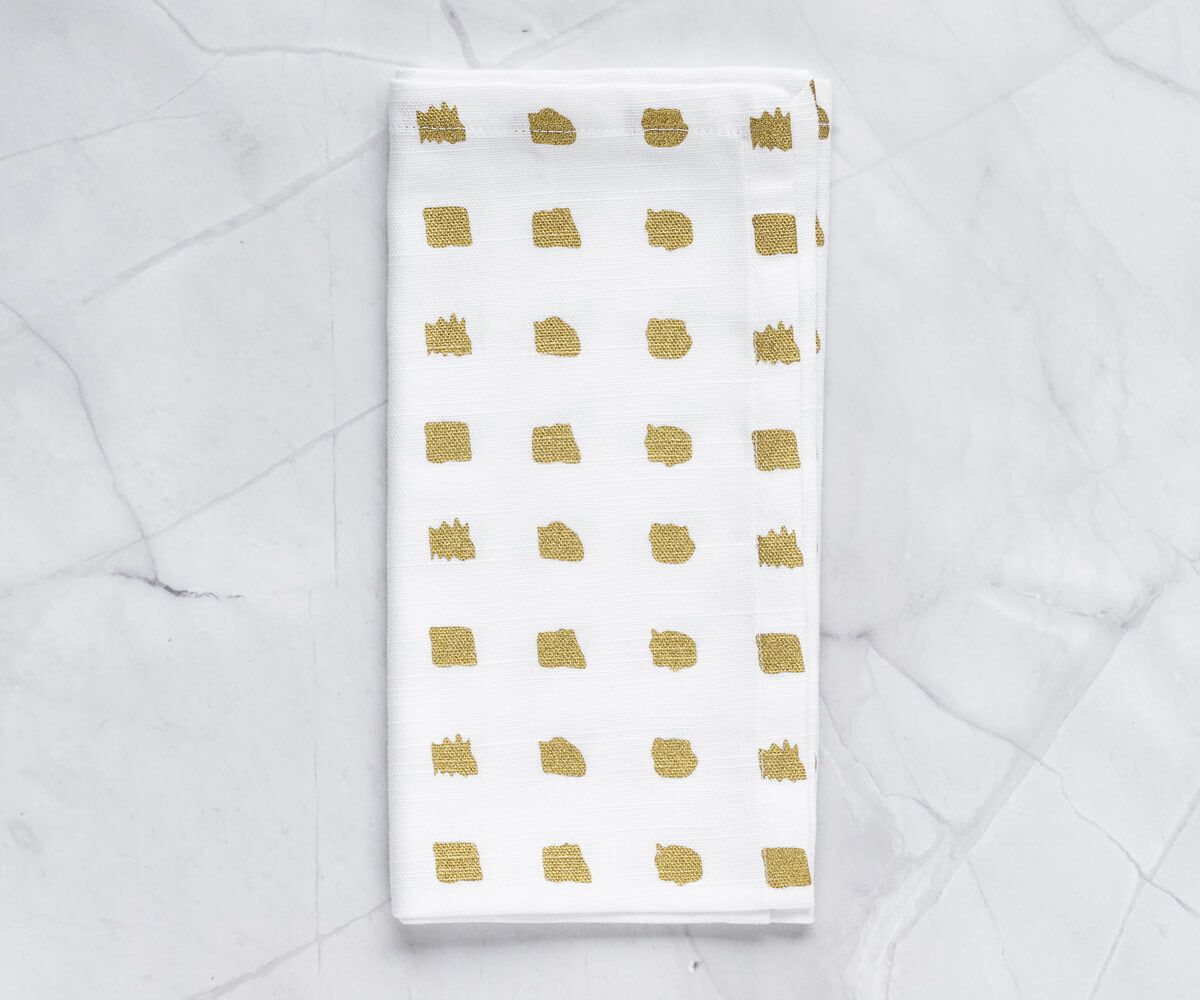 White Napkins with Gold Trim: Adding a touch of opulence to the table.