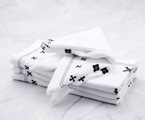 Black cotton napkins Look for cotton napkins with good absorbency to effectively soak up spills and moisture during meals.
