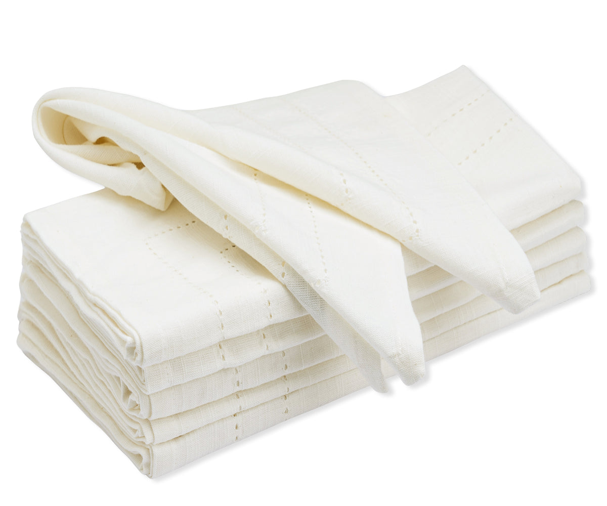 Stack of custom double hemstitch cloth napkins in white color on a plain background