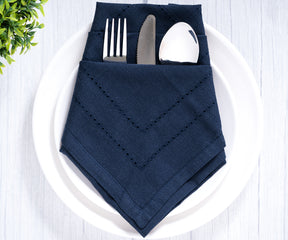 Blue double hemstitch cloth napkin presented with cutlery