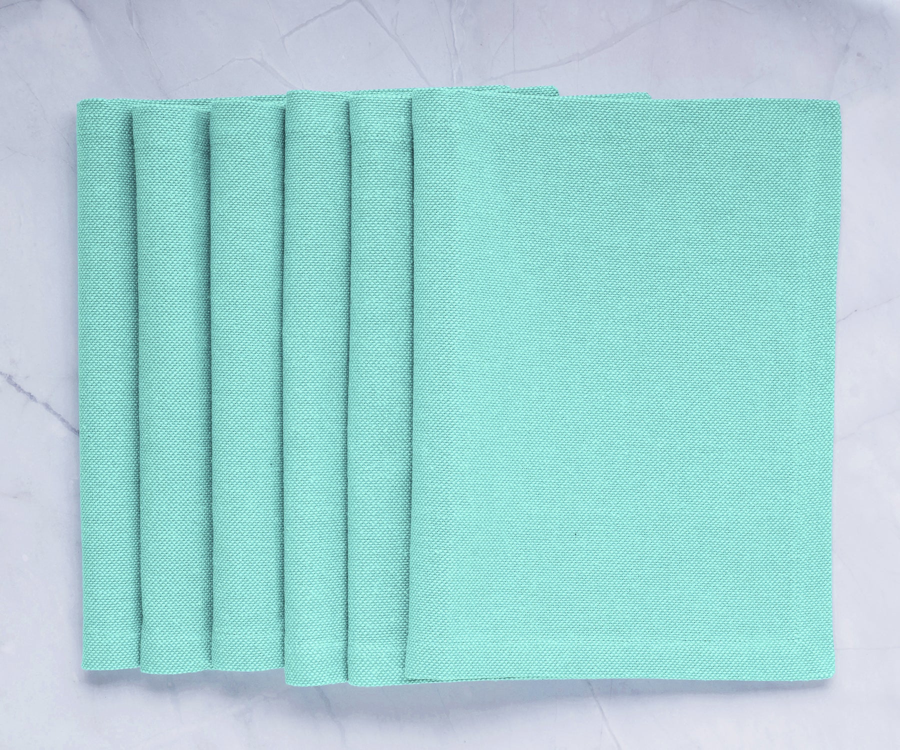 Green fabric placemats: Elevate your dining table with charm and protection, bringing style and practicality to your meals. 