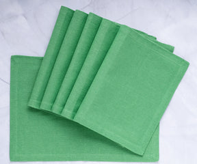 Upgrade your table decor with green fabric placemats, adding a touch of charm and protection, perfect for enjoyable dining moments.