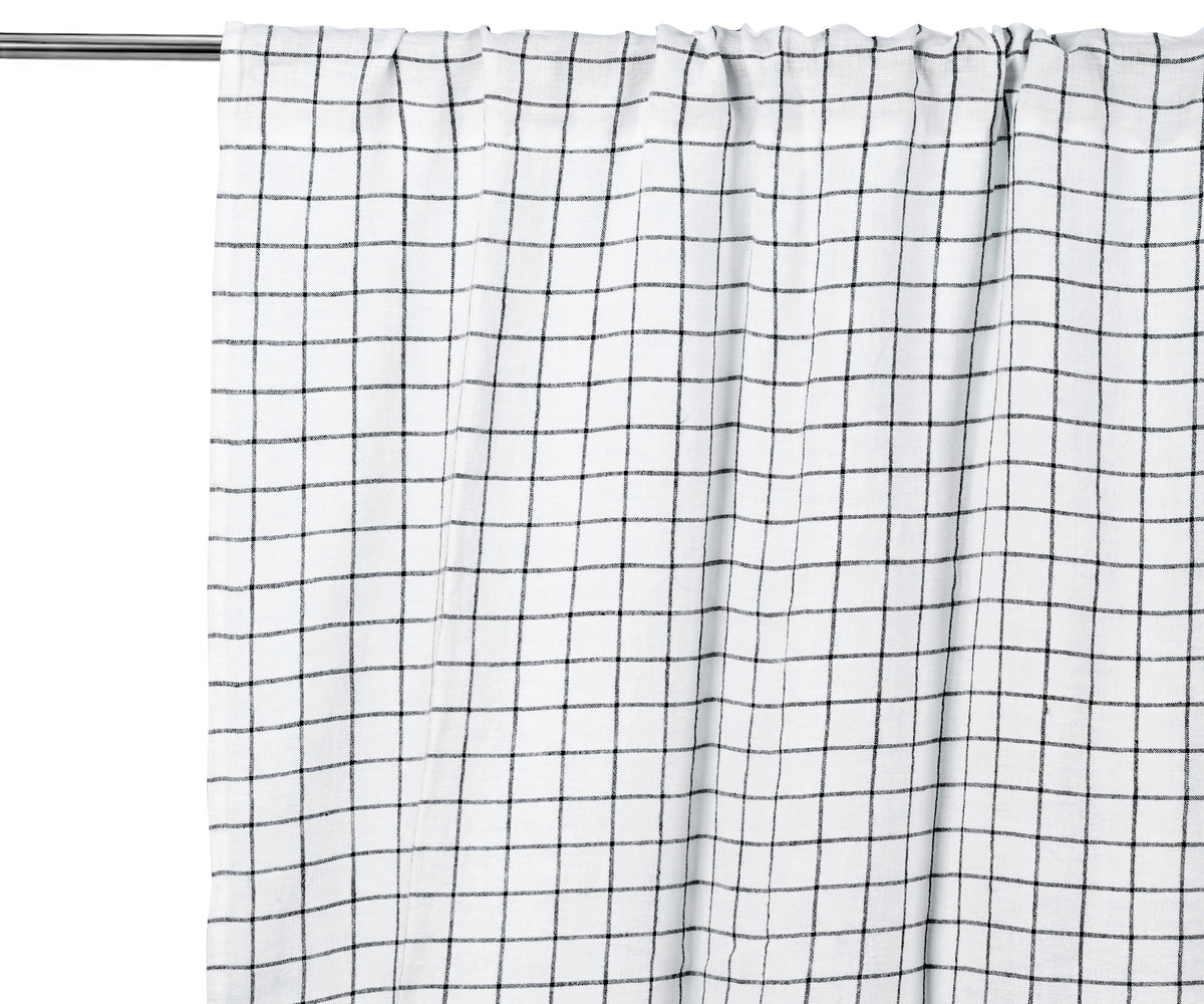 Black grid linen curtain panel, light-filtering, styled in a modern living room