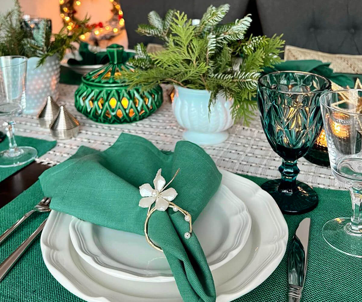 The Green Table Napkins are decorated with flowers and they are arranged neatly. 