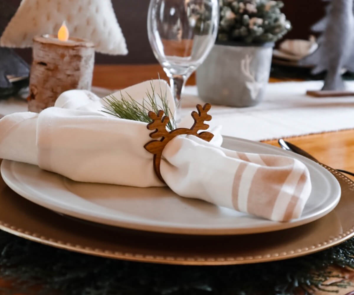 White Cotton napkins with Beige and cream striped napkins - cloth table napkins are folded with grass & placed on the plate on the table.