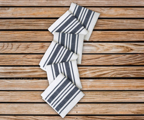 Cotton napkins as blue napkins cloth - Bistro Napkins with blue stripe features navy blue cloth napkins are arranged in the zig zag pattern on the table.