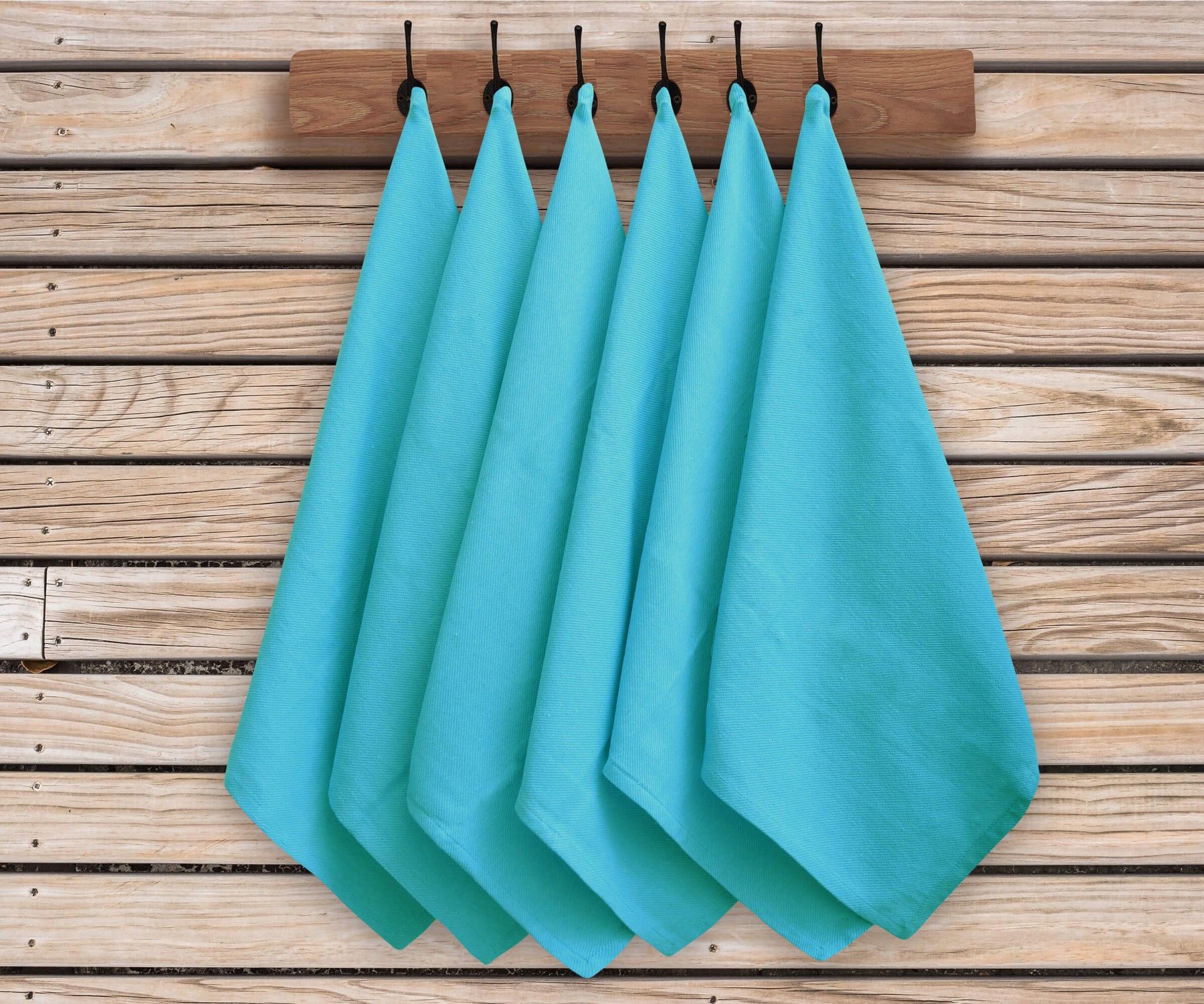 The aqua colour Cloth Napkins set of 6 are folded and hang. 
