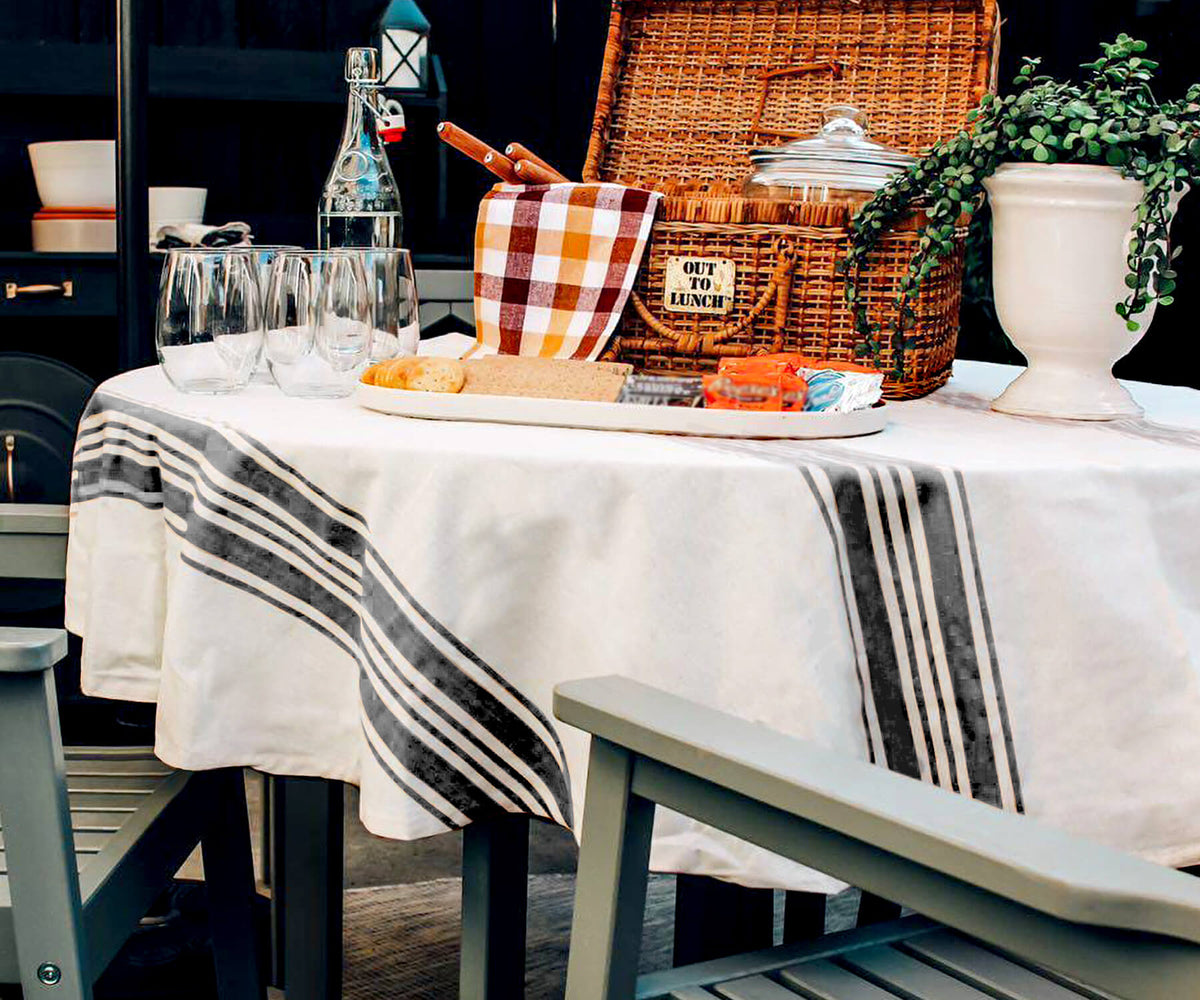 Round outdoor tablecloth adorning a table set up with food and wine | All Cotton and Linen