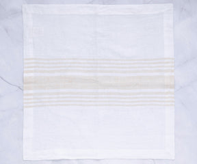 Beige striped linen dinner napkin on a marble background