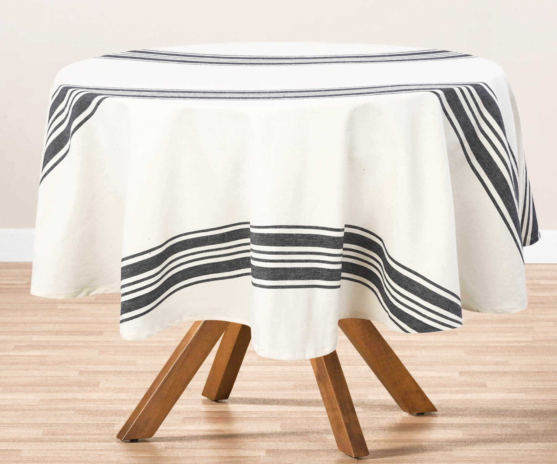 Round outdoor tablecloth with black and white stripes on a table