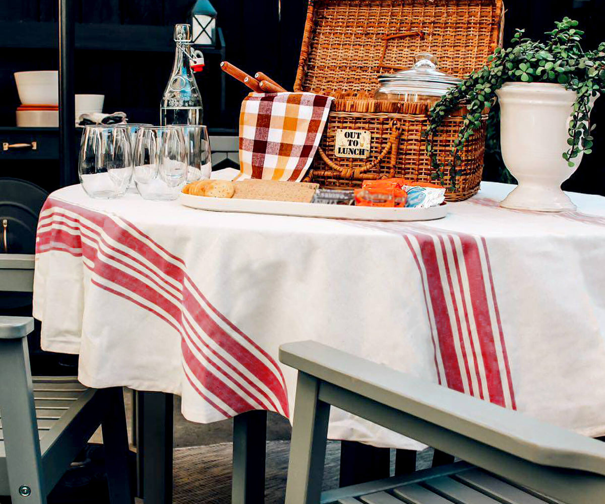 Red and white striped round outdoor tablecloth on a table