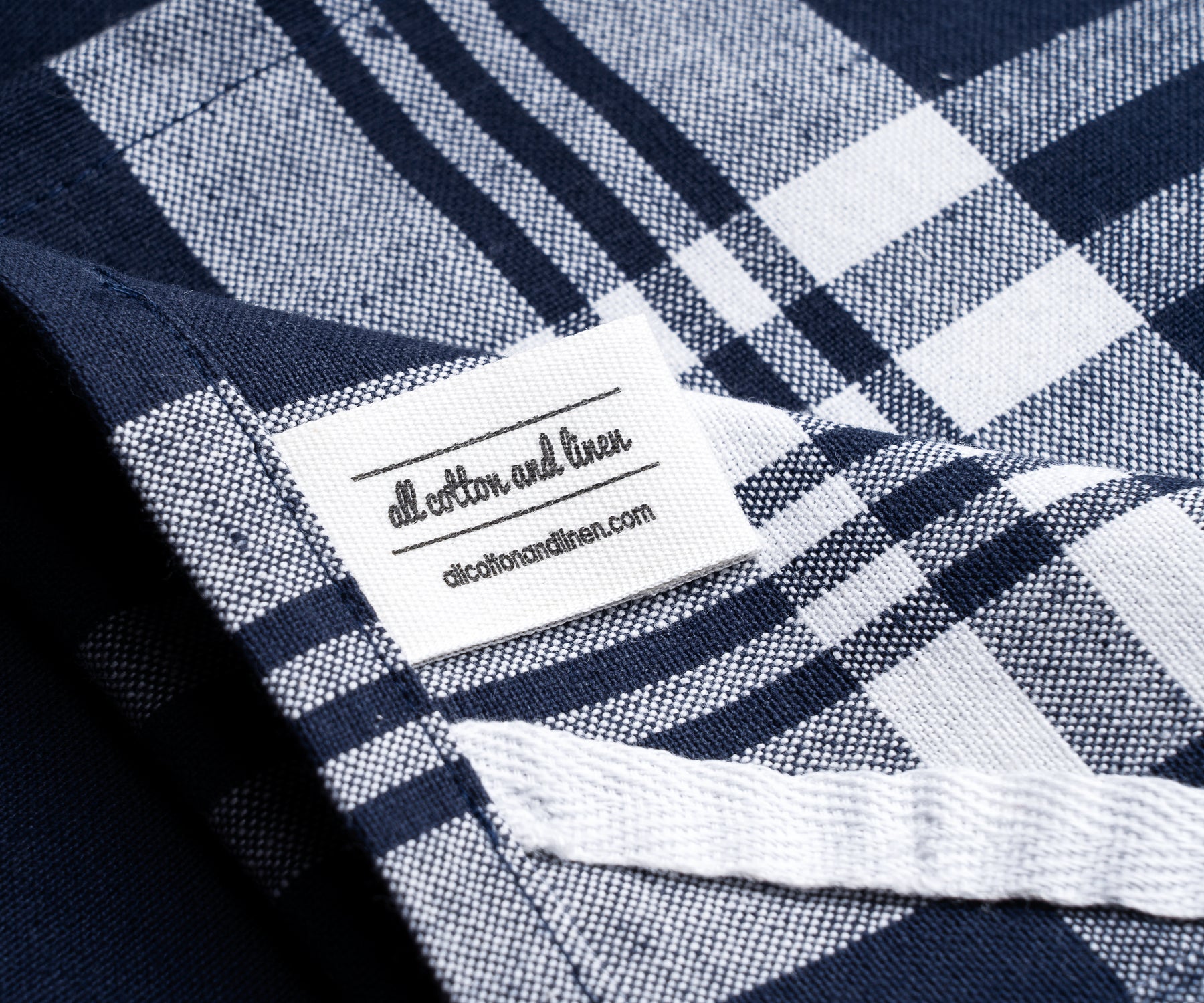 Detail of a farmhouse kitchen towel with blue and white gingham pattern