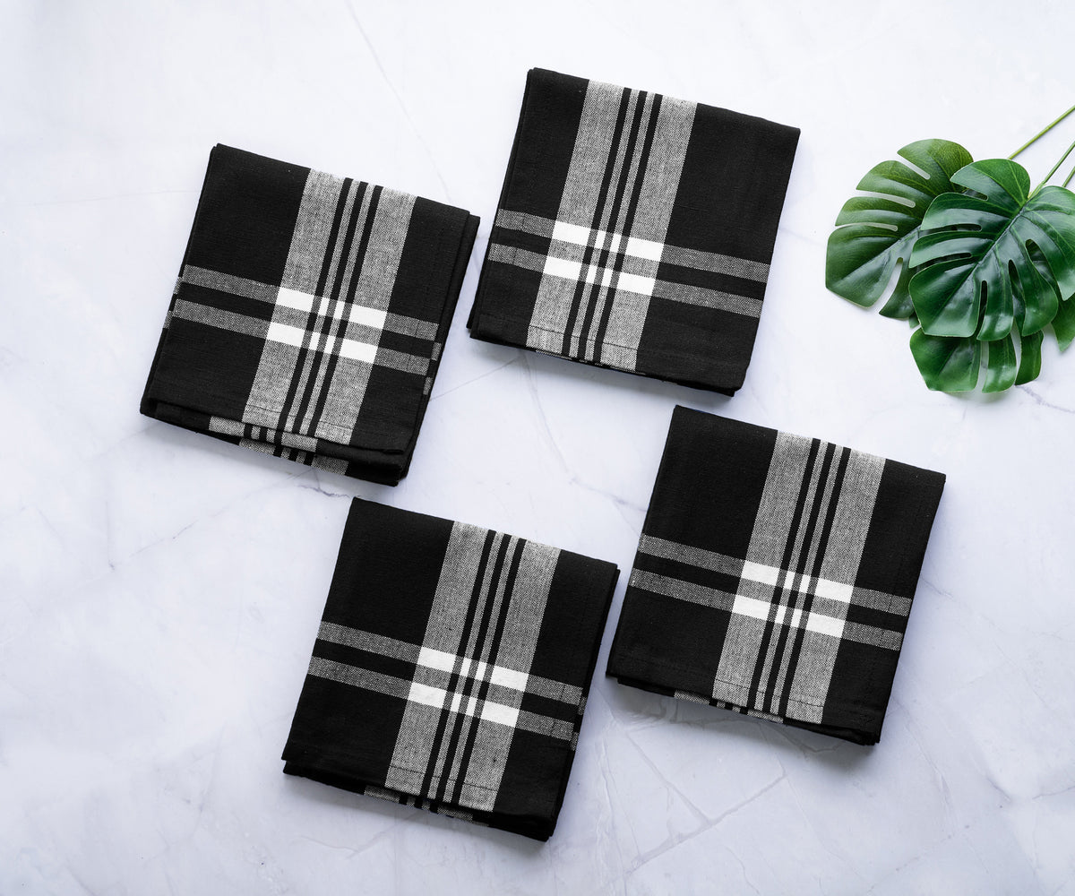 Black and white buffalo plaid kitchen towels arranged on a marble surface