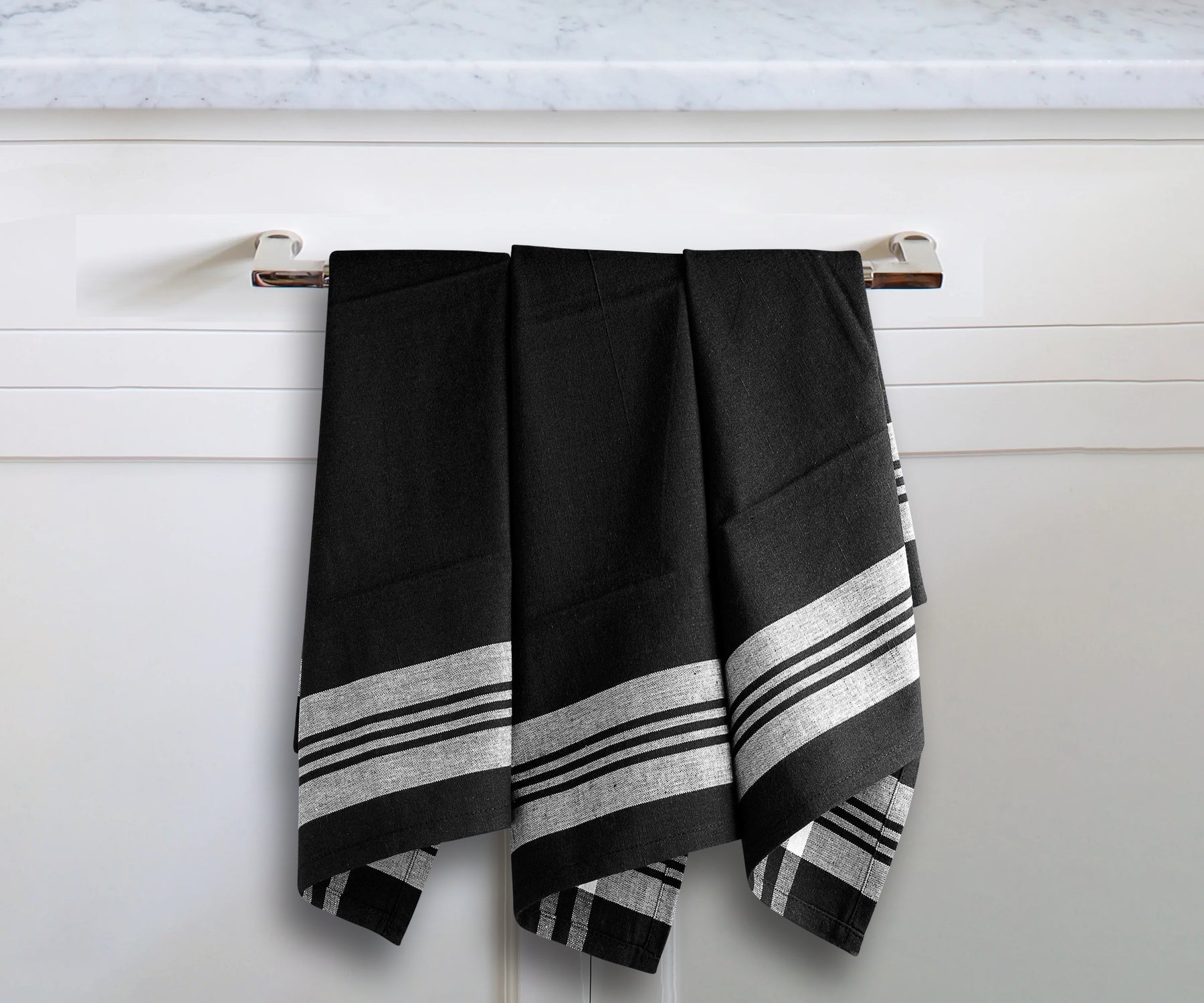 Farmhouse kitchen towel with black and white stripes hanging on a metal hook