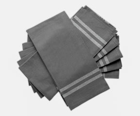 A collection of four farmhouse-style grey kitchen towels with striped borders