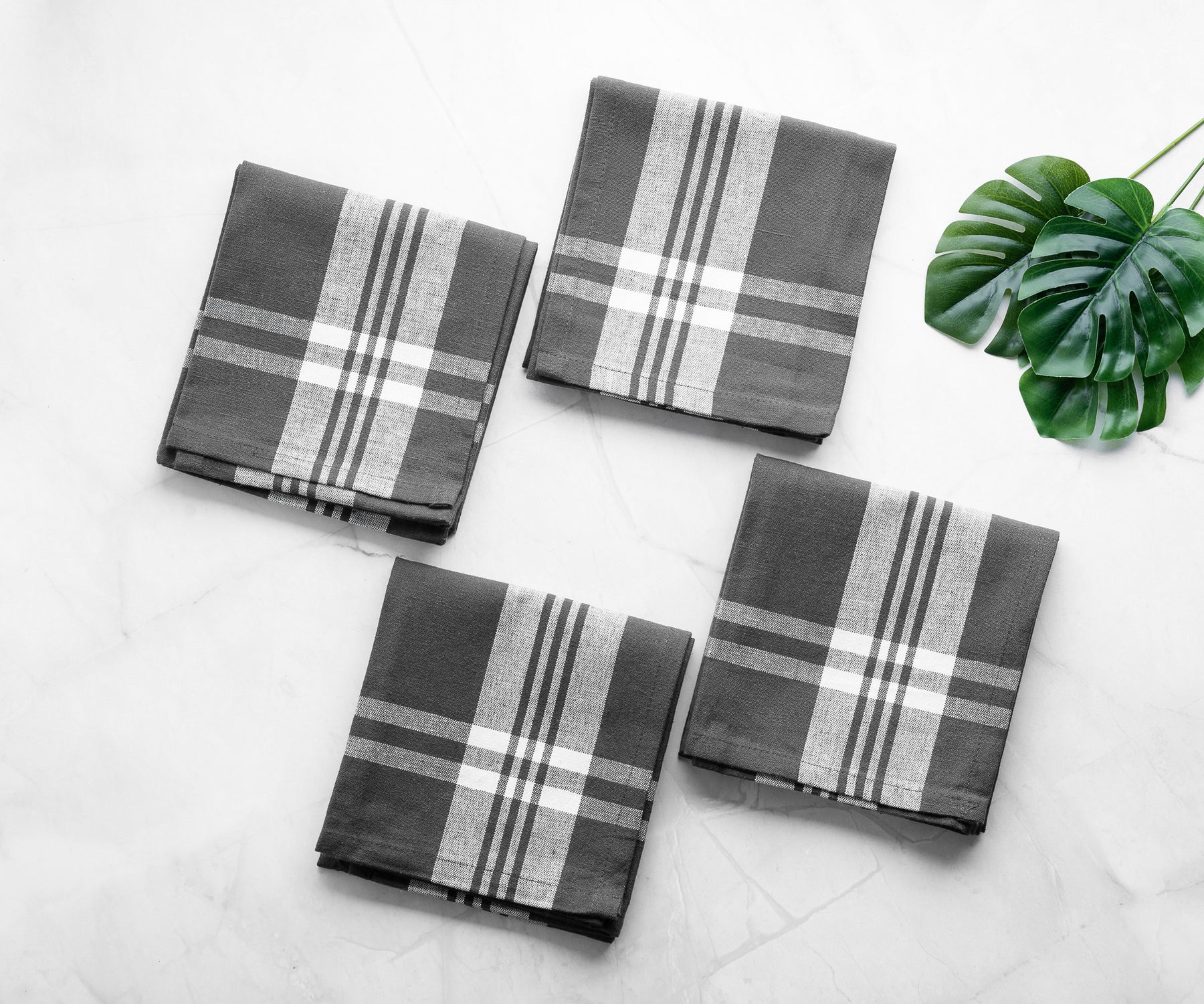 Black and white checkered farmhouse kitchen towels on a marble countertop