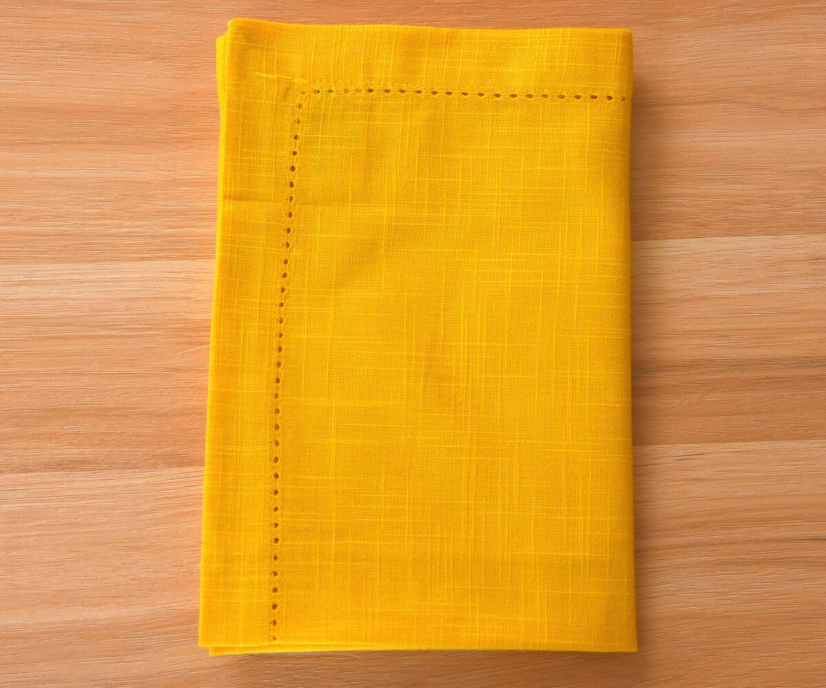 yellow napkins cloth washable with 1-inch border and small folding on floor.
