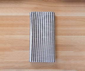Cloth Napkins-A folded cotton napkins in the pattern of  bistro napkins is placed on the table.