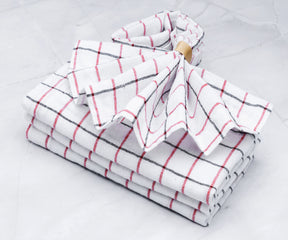 Elegant white table napkins made of cloth, arranged in a decorative pattern.