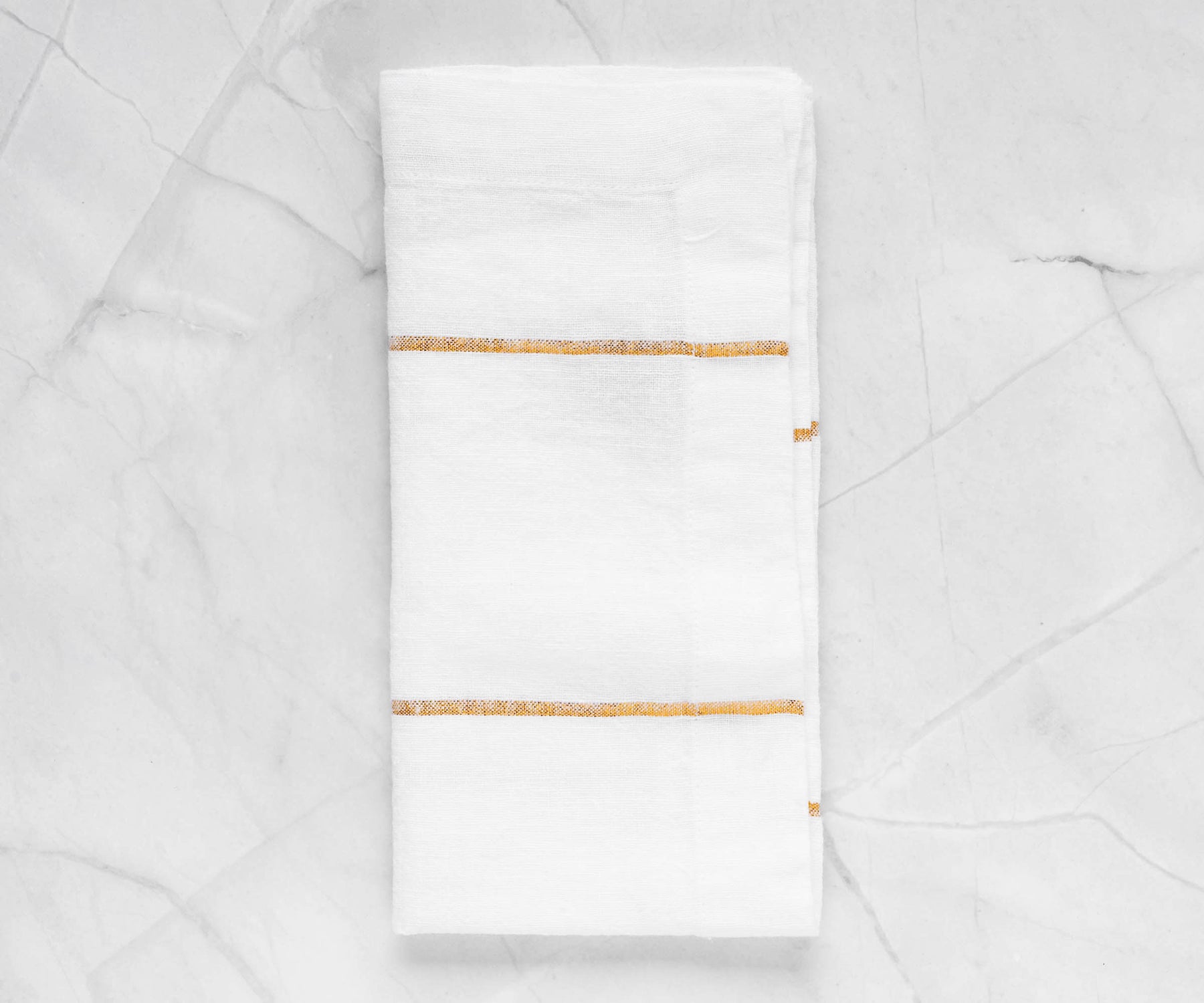Enhance your table presentation with dinner napkins, offering cloth and folding choices in white and black, perfect for a stylish dining experience.Display of Luxurious White and Gold Dinner Napkins Wrapped Around Silverware
