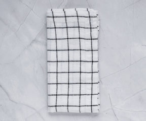 A close-up of neatly folded cloth napkins on a table.