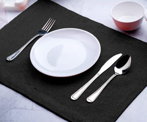 Kitchen table placemats are kept along with the plate and spoon