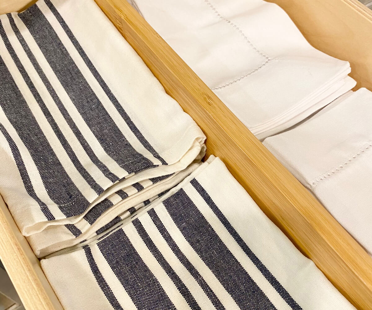 Drawer displaying two white and blue striped bistro napkins