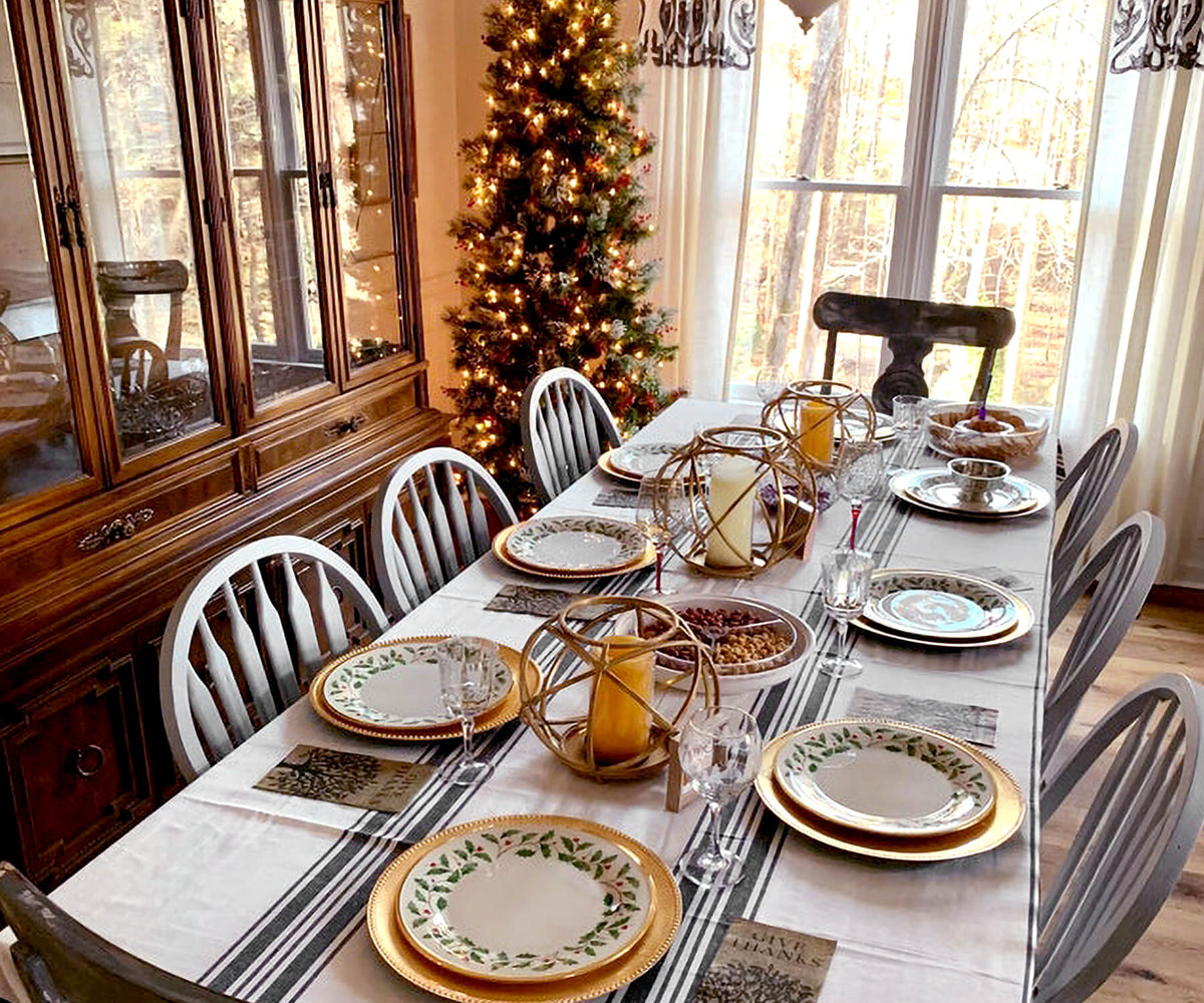 Dining table with Farmhouse tablecloth and Christmas tree in the background