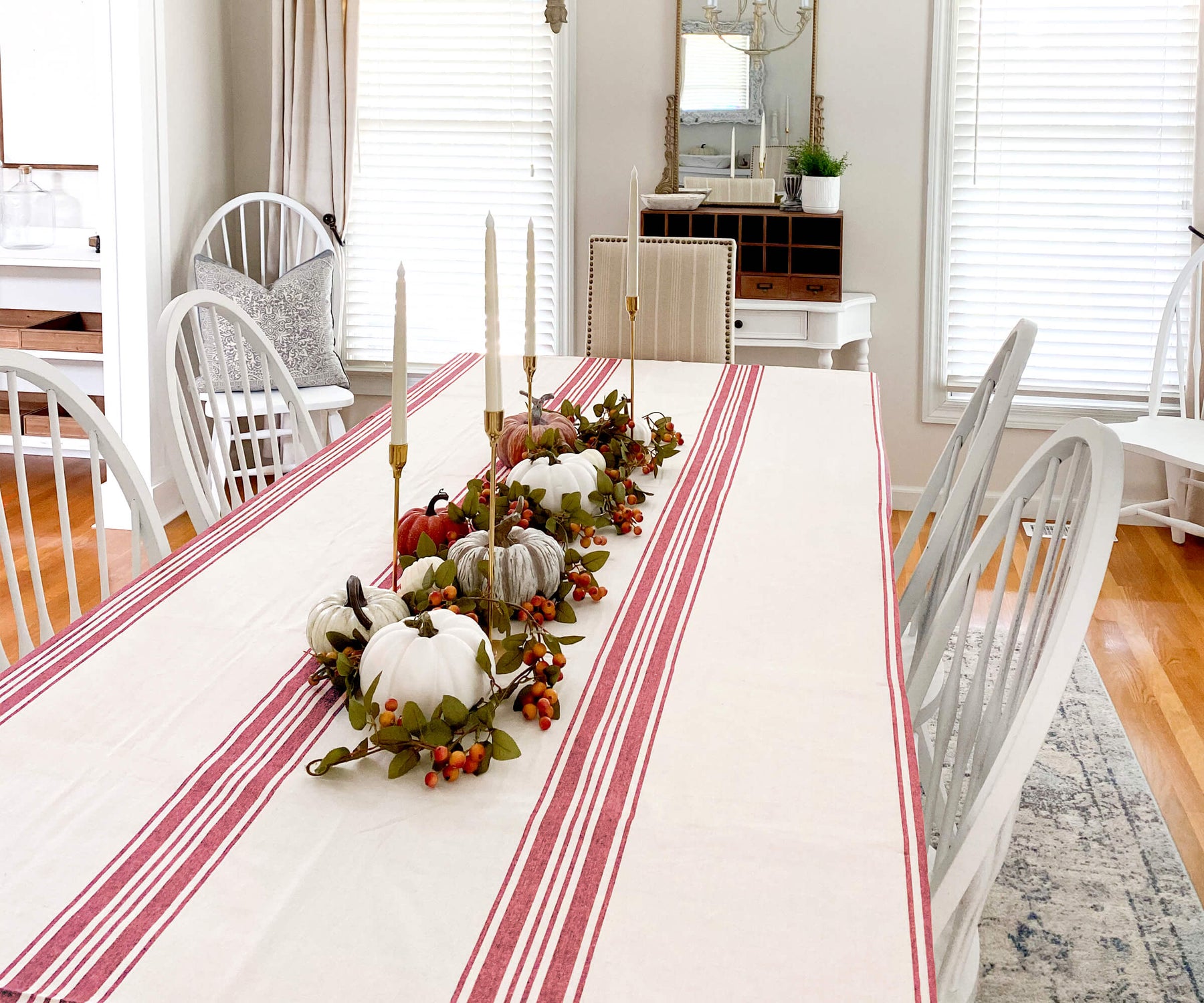 Dining table adorned with red and white striped Farmhouse tablecloth