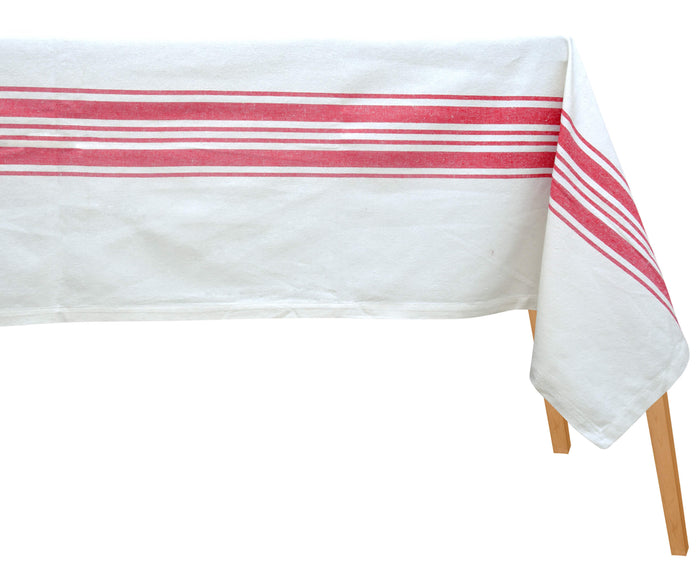 White tablecloth with red stripes on a wooden table.