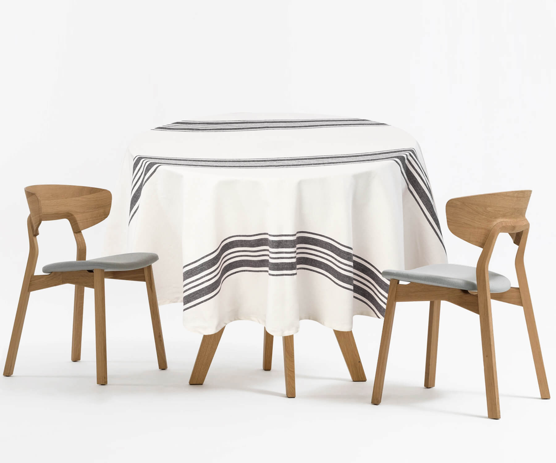 Round outdoor tablecloth on a table setup with two chairs