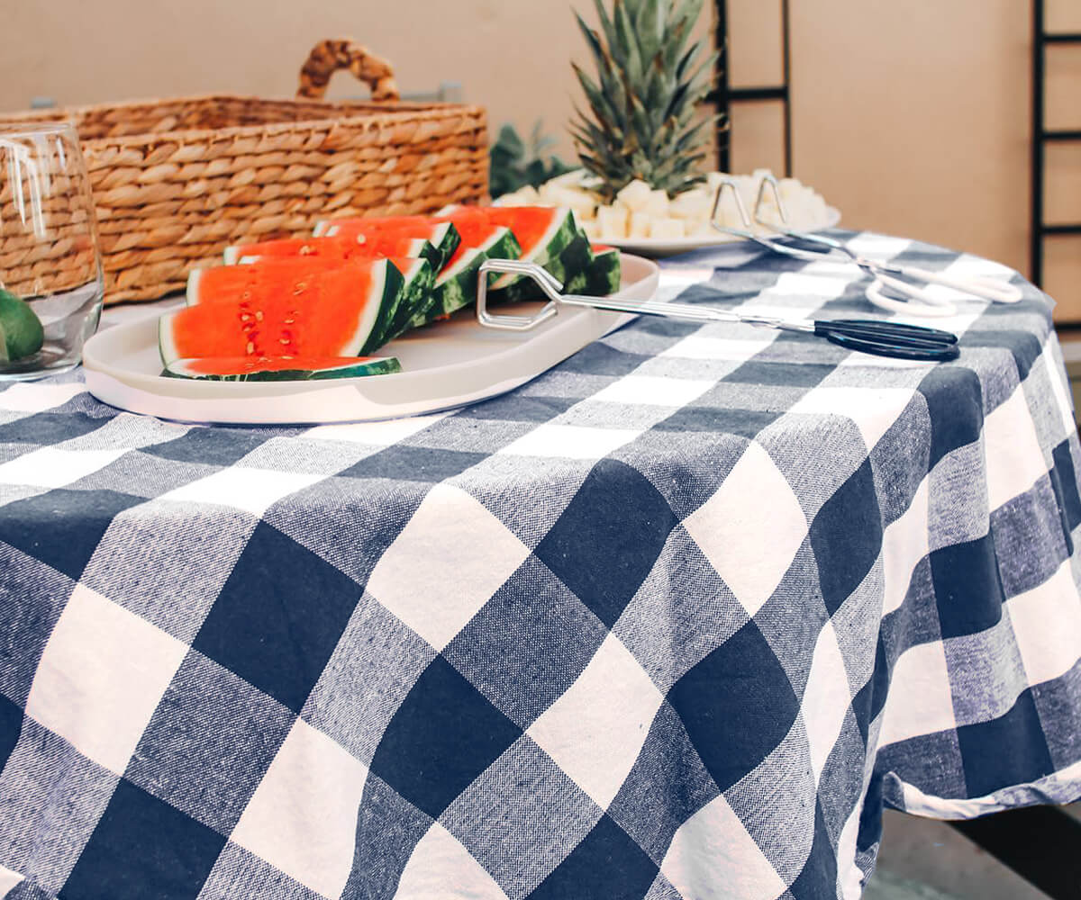 Round tablecloth with watermelon print and actual watermelon slices on top