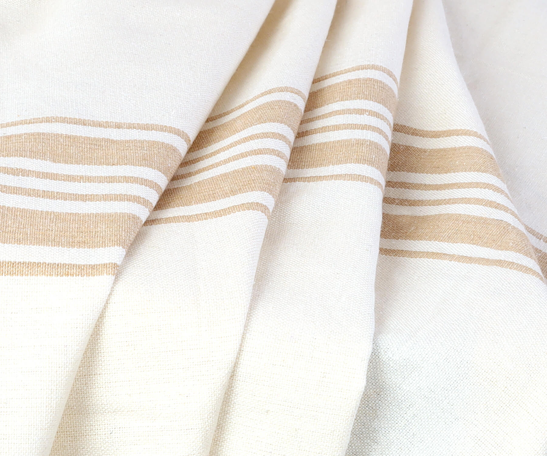 Close-up view of a round outdoor tablecloth with white and tan stripes