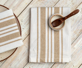 Wooden spoon resting on a striped restaurant napkin