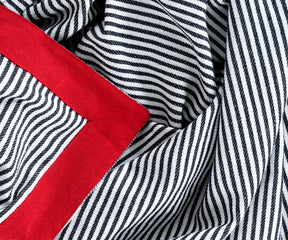 Close-up view of Farmhouse tablecloth with red trim