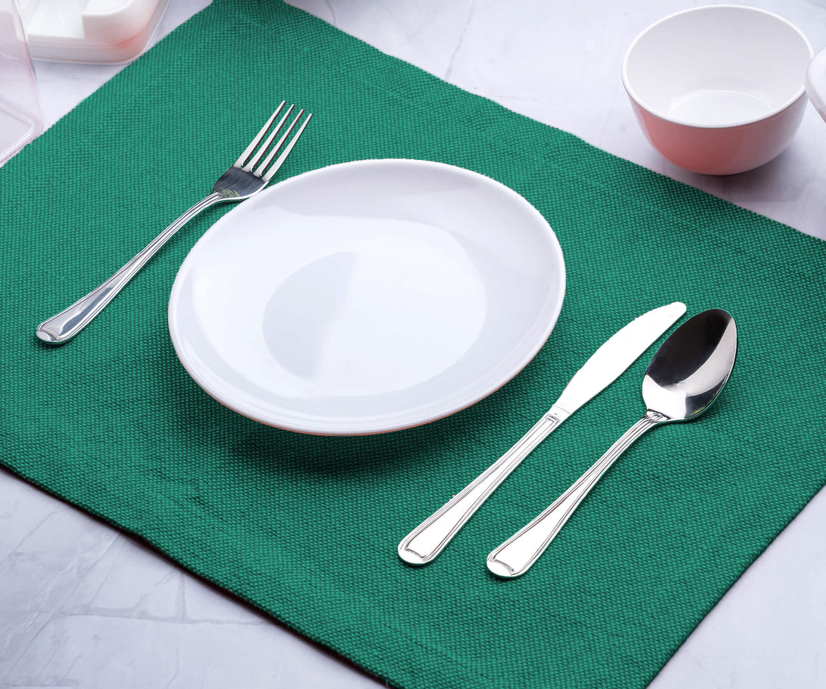 Teal placemats -placemats for dining table with shade of Teal Green are placed with plate and spoon. 