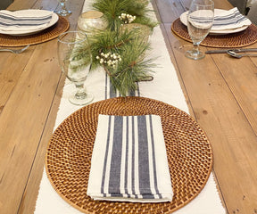 A table setup featuring six bistro napkins with blue and white stripes