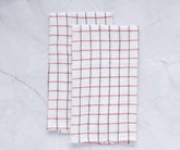 Simple, natural-colored linen kitchen towel hanging beside a stove. Practical and stylish for everyday kitchen use.